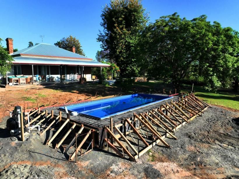 A Swimming Pool Is Being Built in Front of A House — Spencer's Landscape Construction & Concreting Pty Ltd in Dubbo, NSW