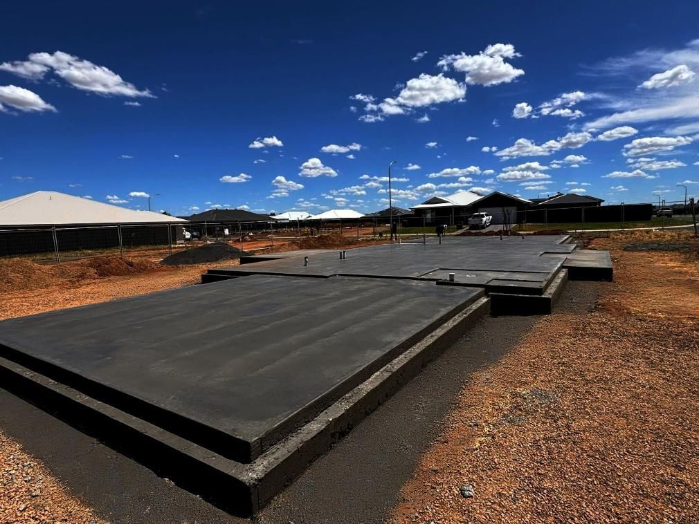 A Large Concrete Slab Sitting in The Middle of A Field — Spencer's Landscape Construction & Concreting Pty Ltd in Dubbo, NSW