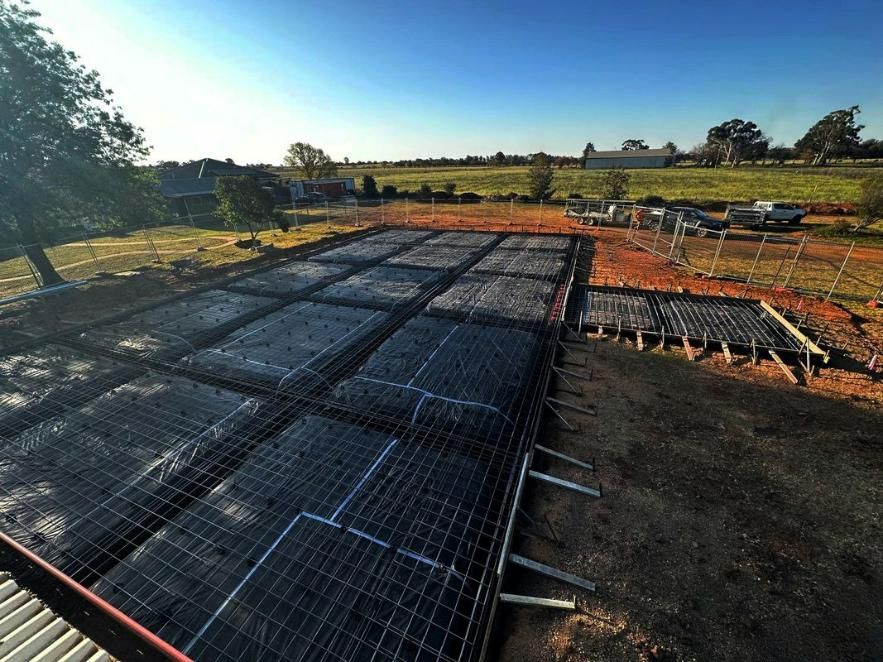 A Large Concrete Slab Is Being Built in A Field — Spencer's Landscape Construction & Concreting Pty Ltd in Dubbo, NSW