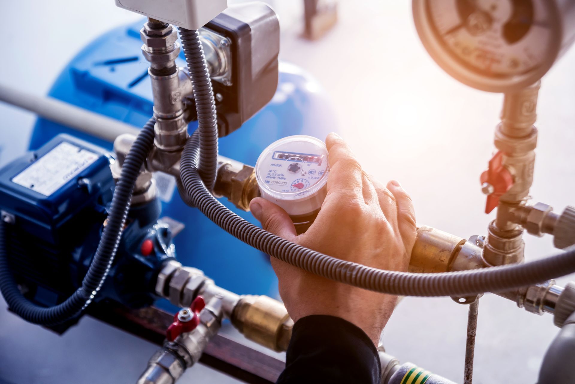 A person is holding a water meter in their hand.