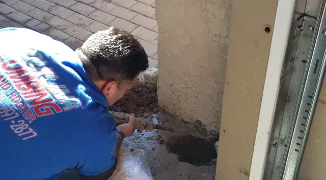 A man is fixing a boiler with a wrench in South Bay, CA
