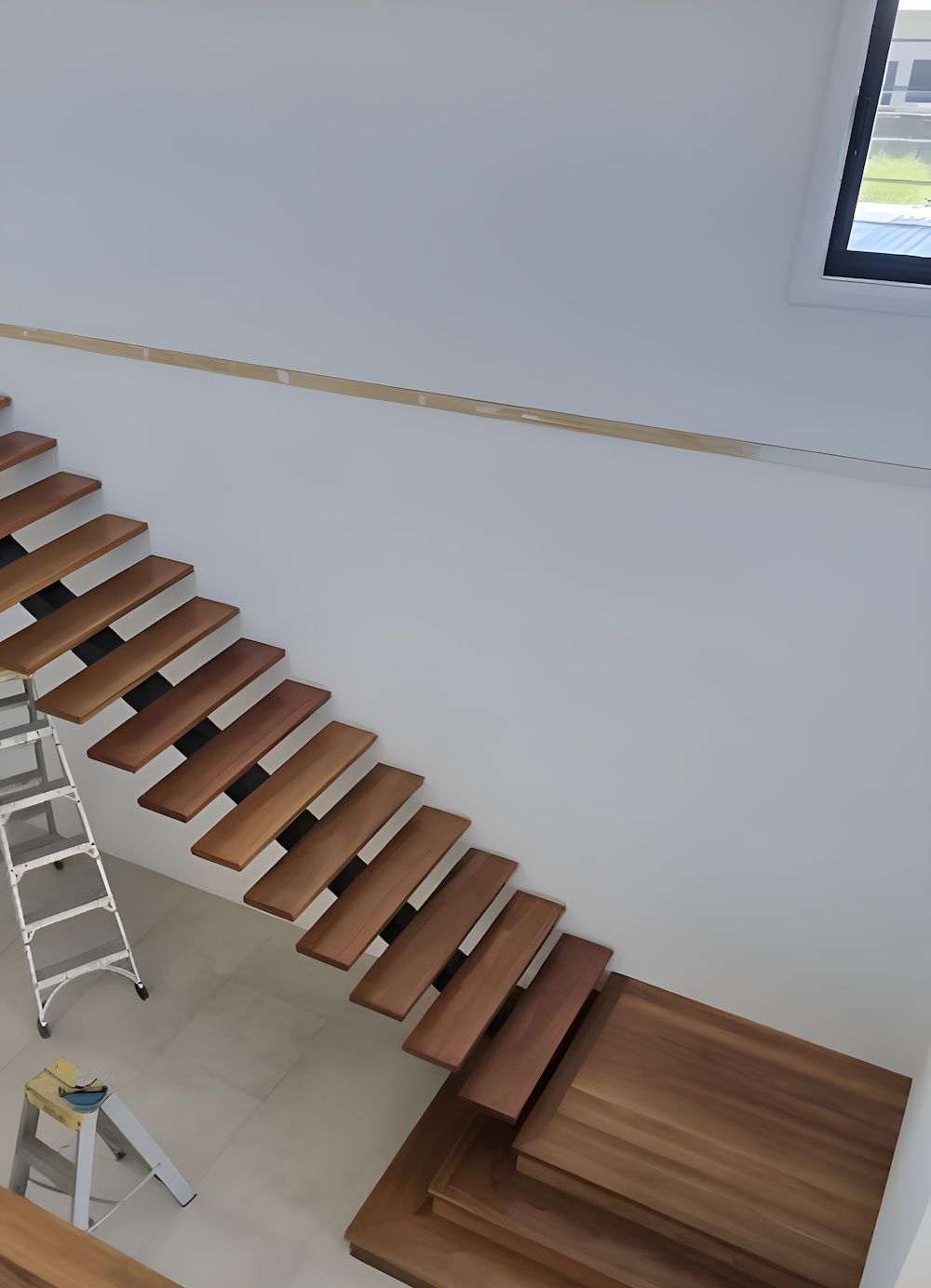 A Wooden Staircase With A Ladder Next To It — European Floor Sanding In Mount Louisa, QLD