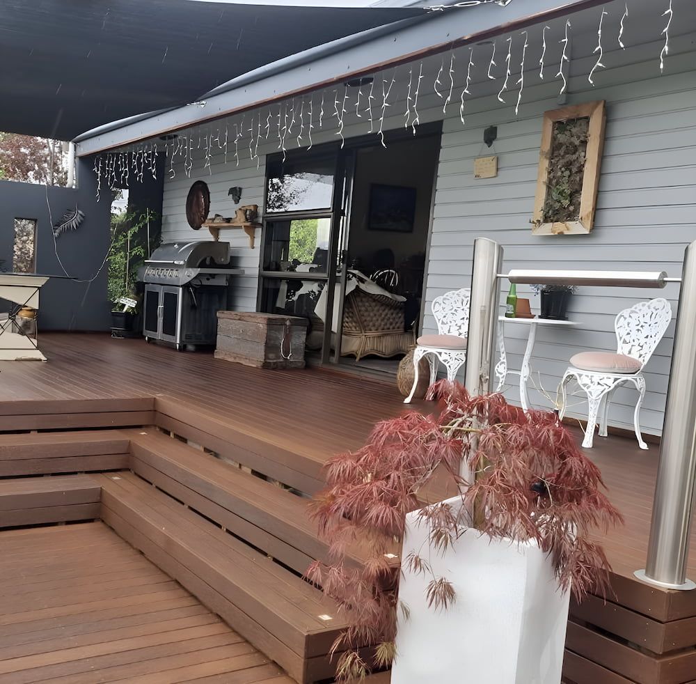 A House With A Wooden Deck And Stairs — European Floor Sanding In Mount Louisa, QLD