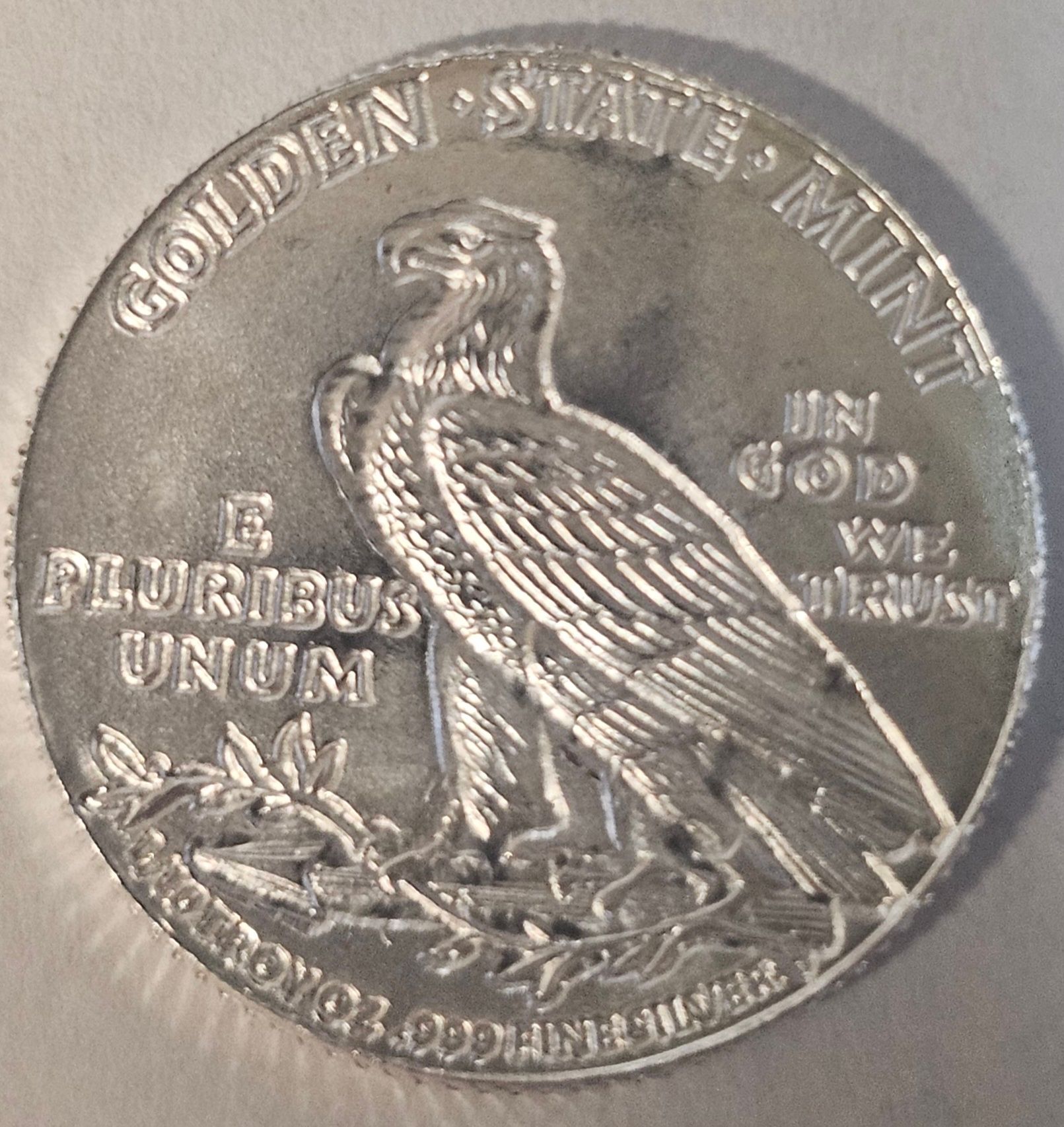 Silver coin with profile of a Native American in headdress,