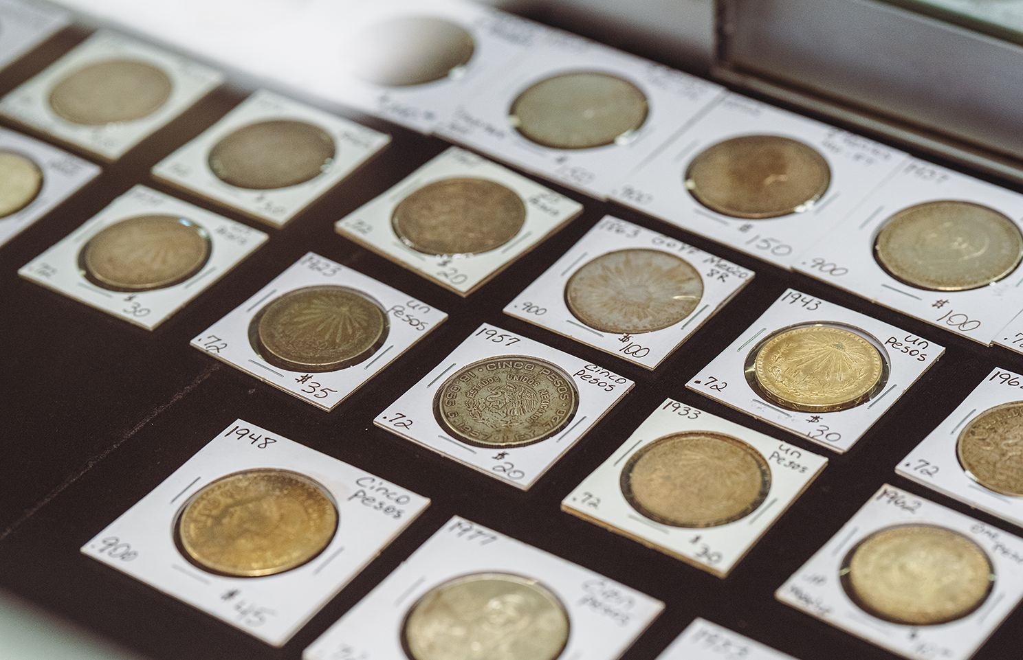 Coins in coin holders on display.