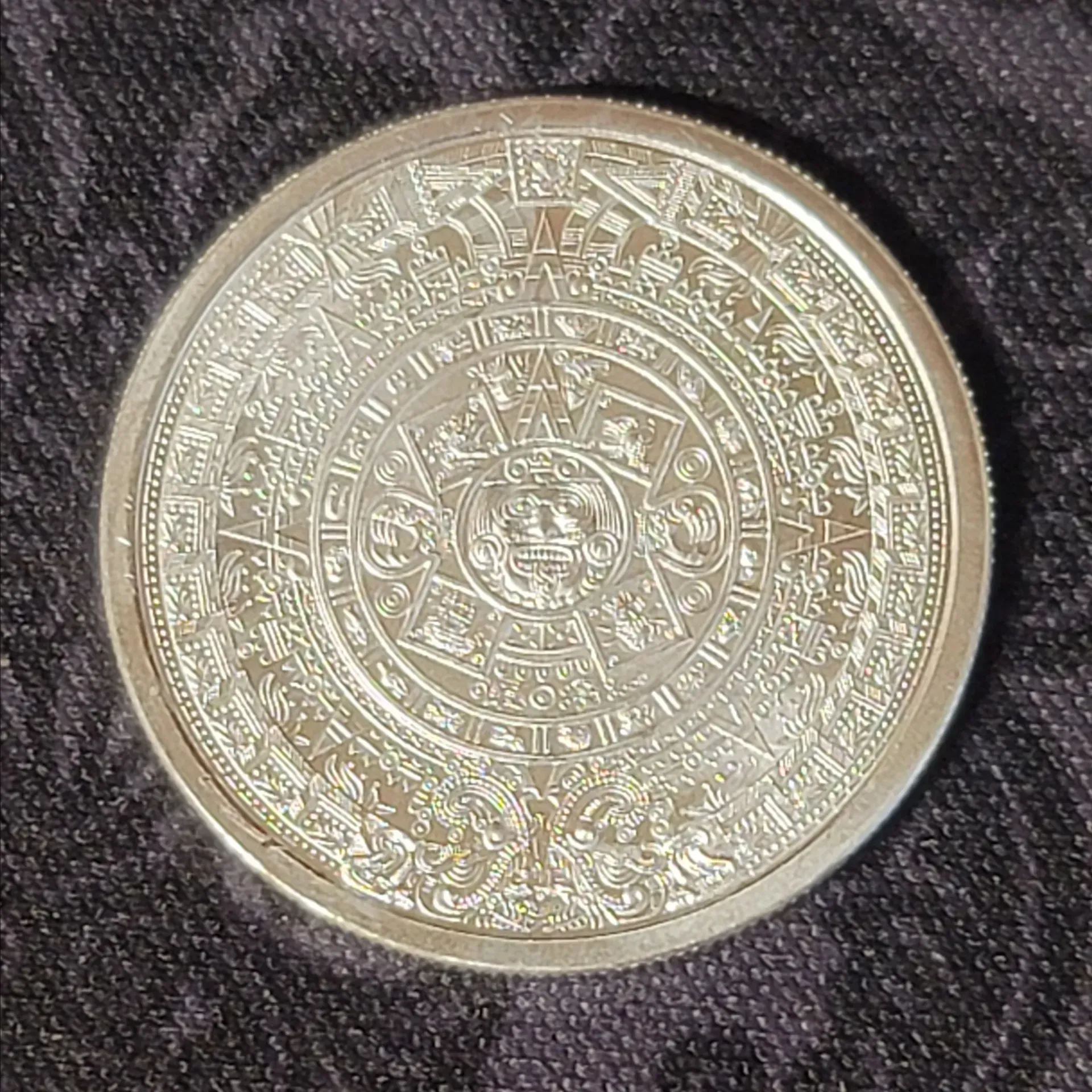 Silver coin with the profile of a person wearing a headdress; text: Quarter Troy Ounce .999 Fine Silver.