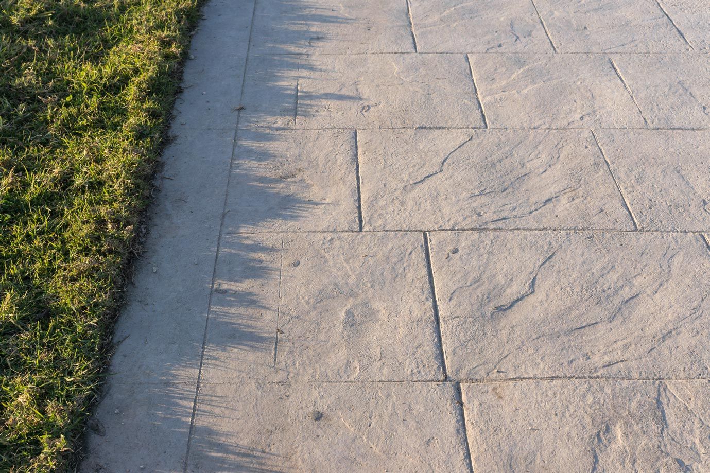 Stamped concrete walkway by Keenan Concrete, showcasing custom concrete designs by local concrete co