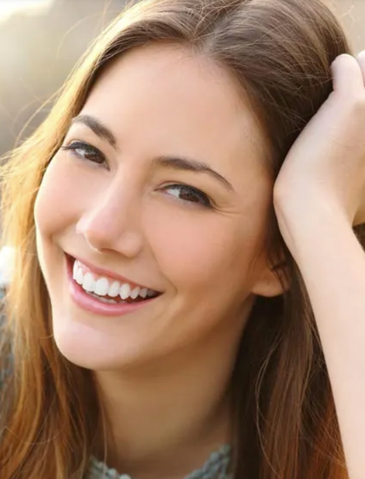A Woman smiling after getting her teeth done — Teeth Whitening in Central Coast, NSW