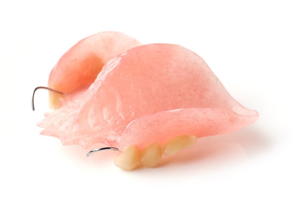 A Close Up Of A Denture On A White Background — Dentures on the Central Coast, NSW