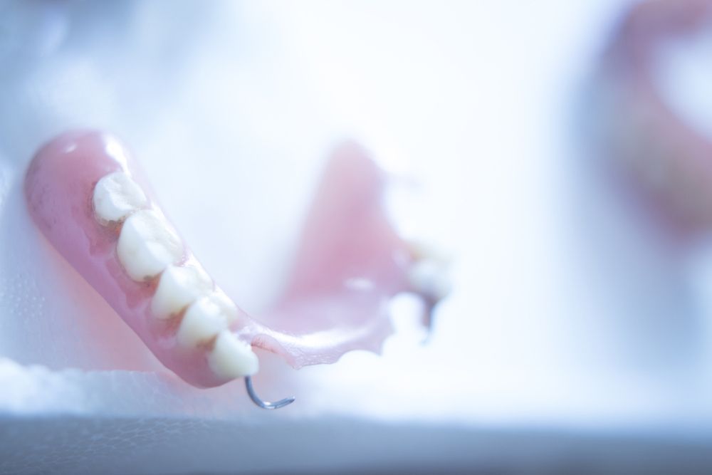 A Close Up Of A Denture On A Table — Dentures in Long Jetty, NSW