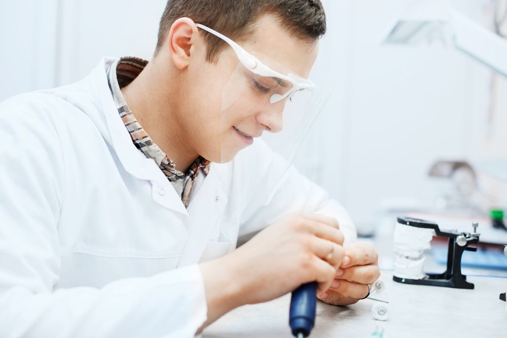 A Dentist Is Working On A Denture Alignment — Dentures in Port Macquarie, NSW