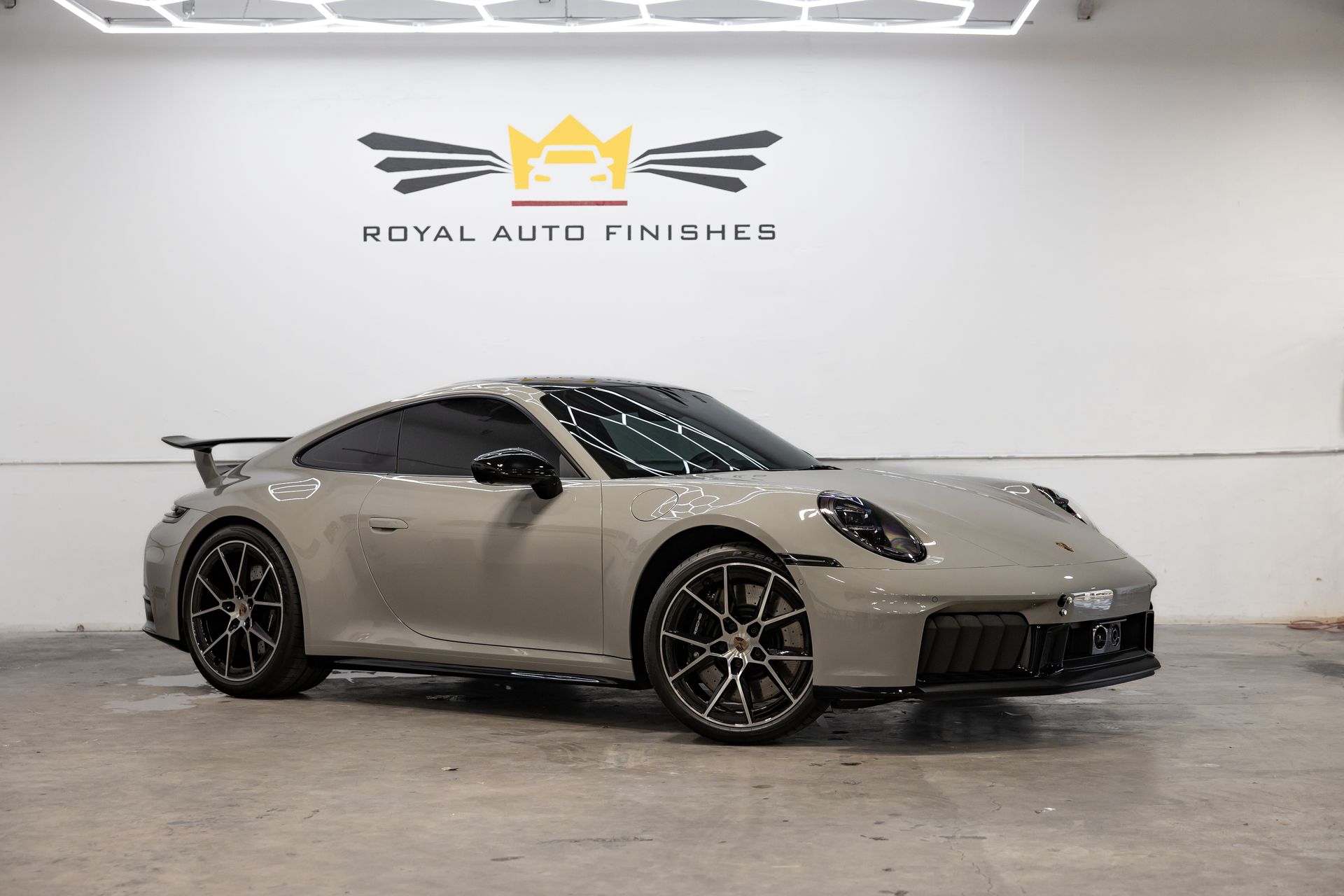 Red Porsche 911 sports car inside a bright shop.