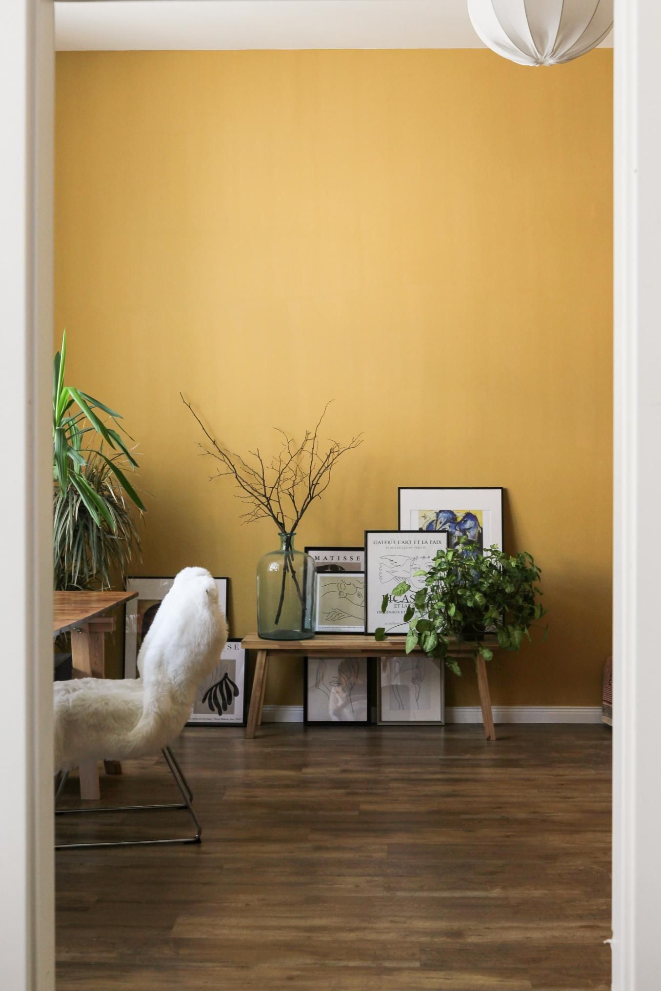 A Room With a Yellow Wall and a Table With Pictures on It — Painters in Lismore, NSW 
