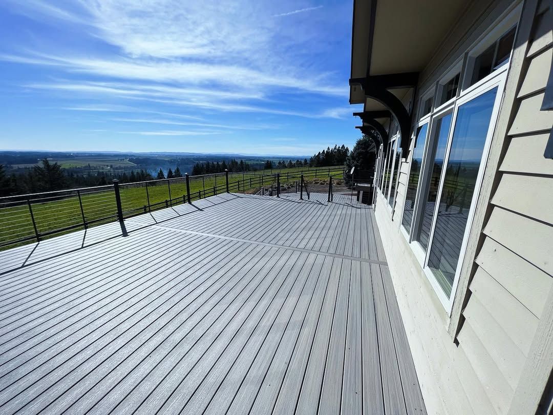 Deck with gray composite decking, black railing.