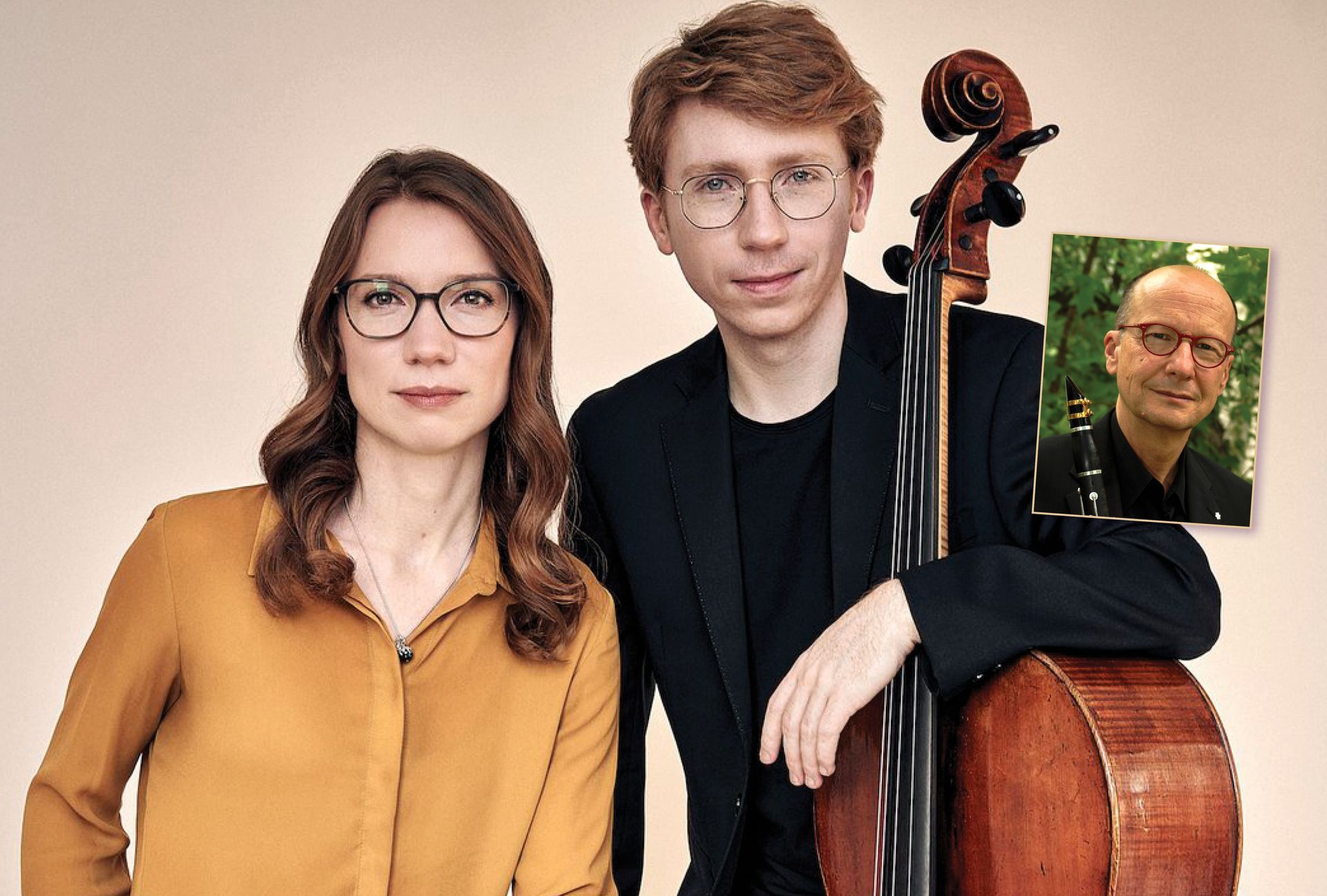 A man and a woman are sitting next to each other next to a cello.