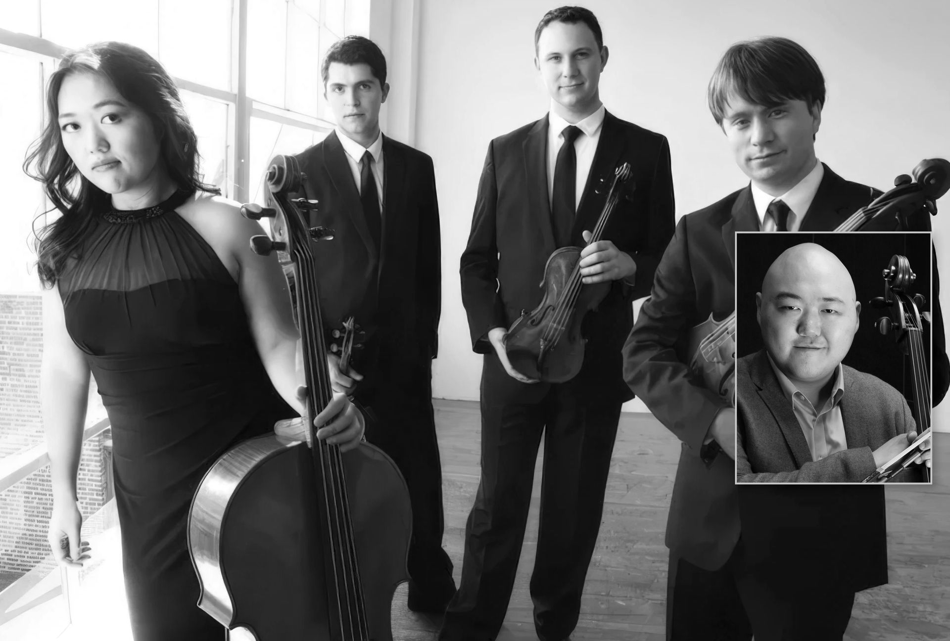 A group of people standing next to each other holding violins.