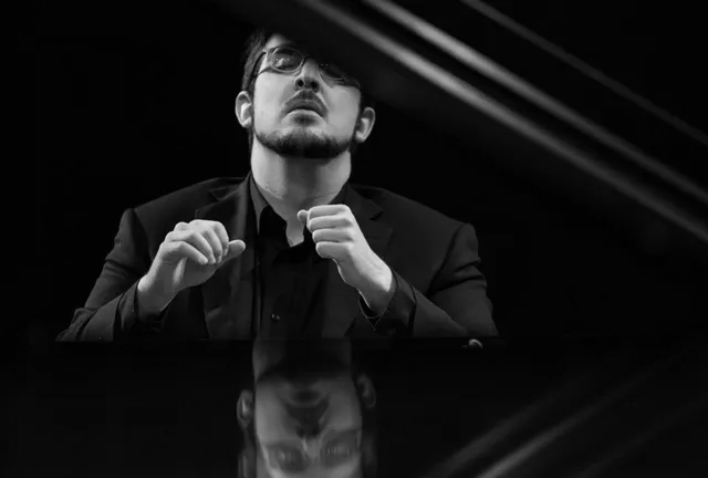 A group of men are standing next to each other holding saxophones.