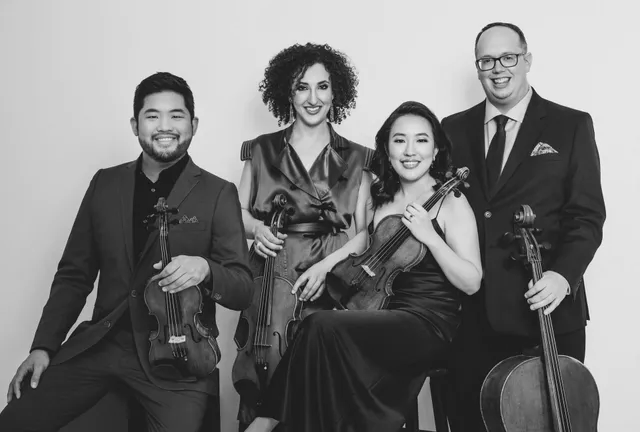 A man is playing a cello and a woman is playing a piano.