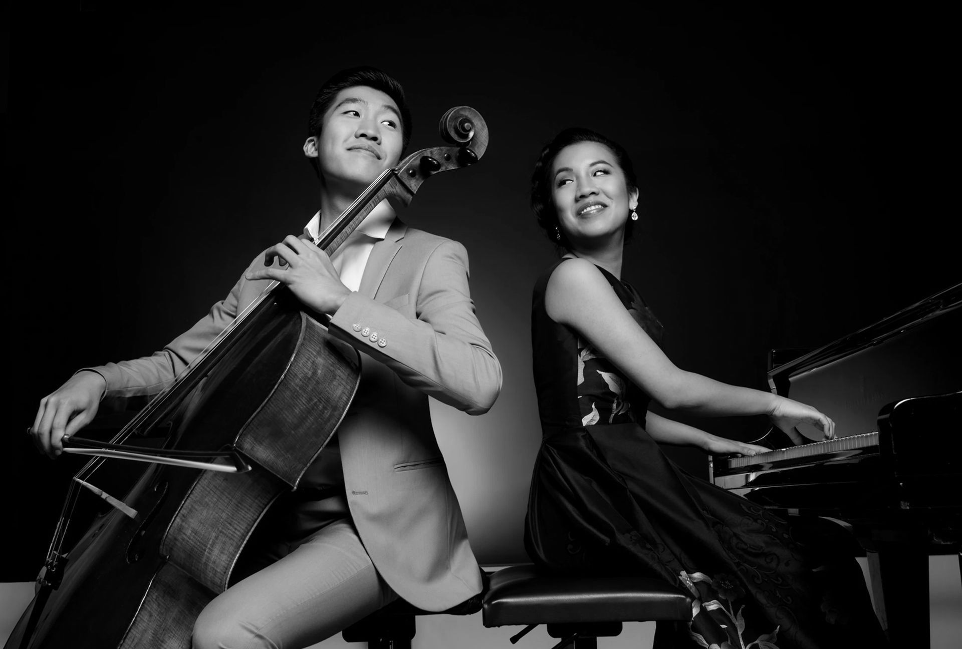 A man is playing a cello and a woman is playing a piano.