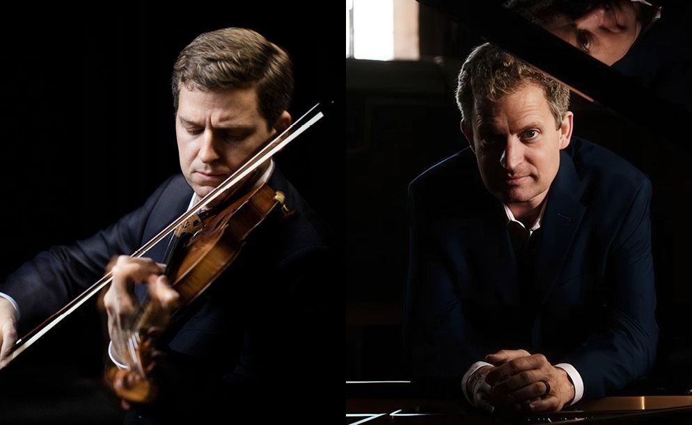 Two musicians in dark suits: one playing a violin on the left, the other leaning over a piano on the right, dark background.