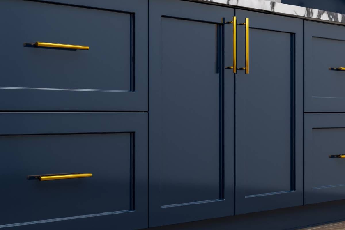 Navy Blue kitchen cabinets with golden metal handles and accents