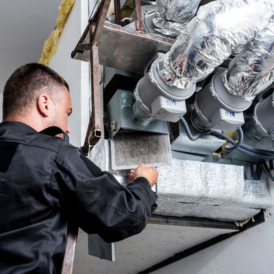 ProTech Athens | a man is working on a ventilation system in a building.