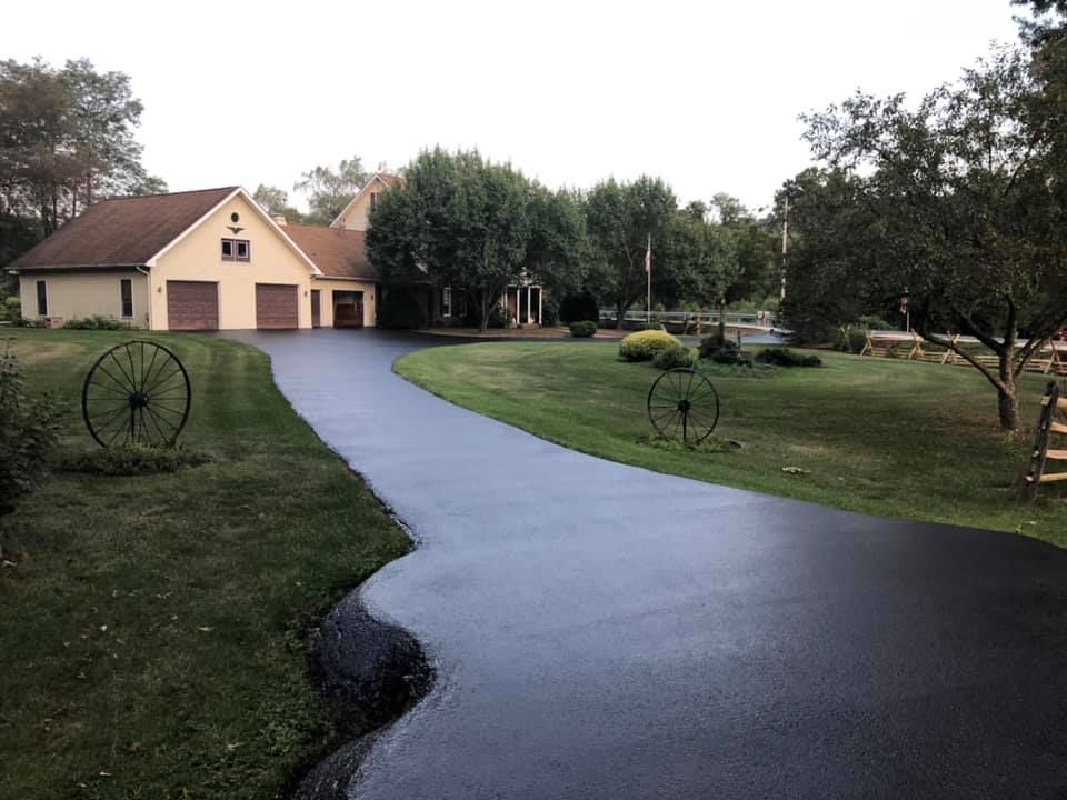 A large house with a large driveway leading to it