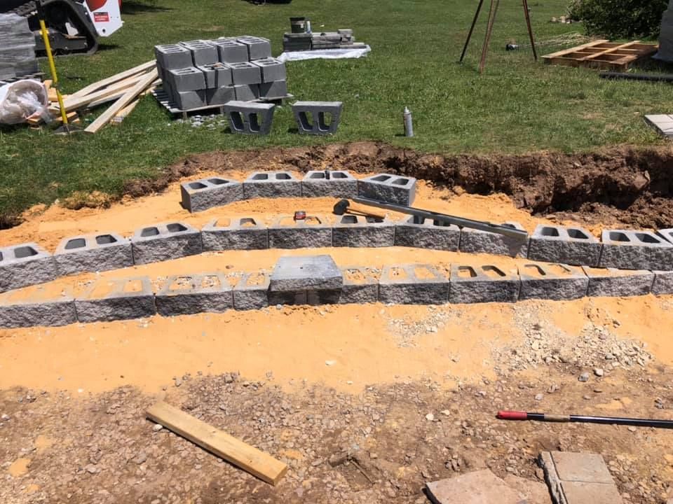 A bunch of bricks are sitting on top of a pile of dirt.