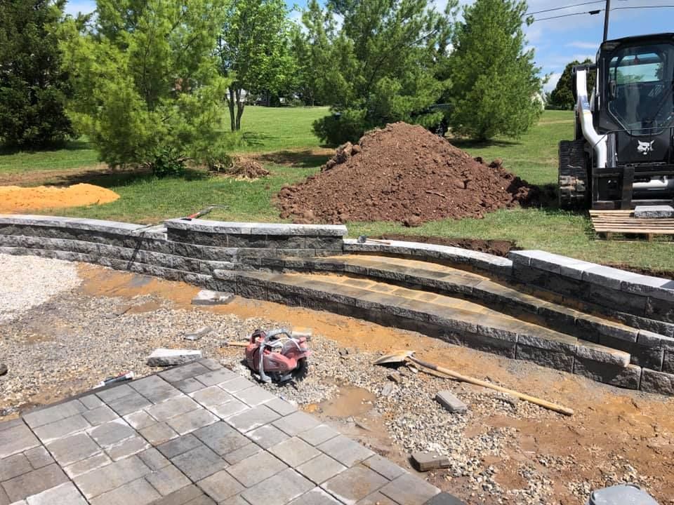 A construction site with a bulldozer and a pile of dirt in the background.