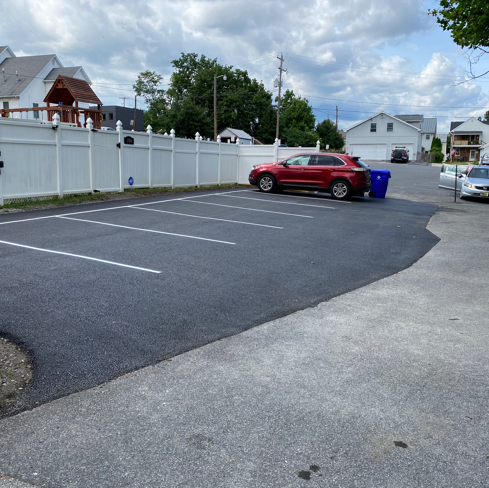 A red car is parked in a parking lot