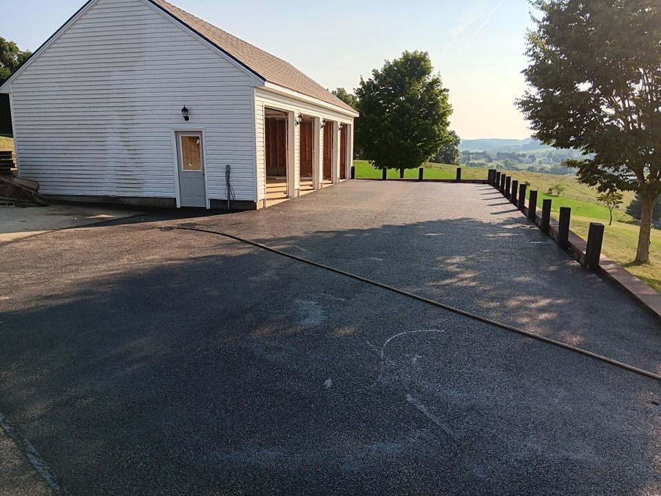 A white building with a driveway leading to it