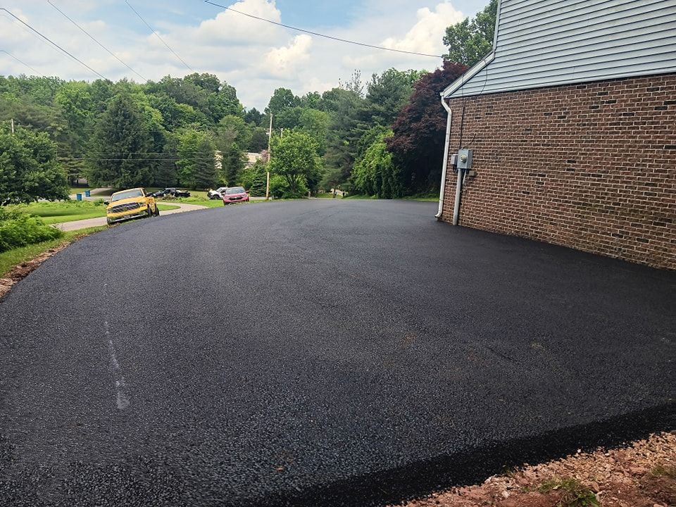 A brick building with a driveway in front of it.