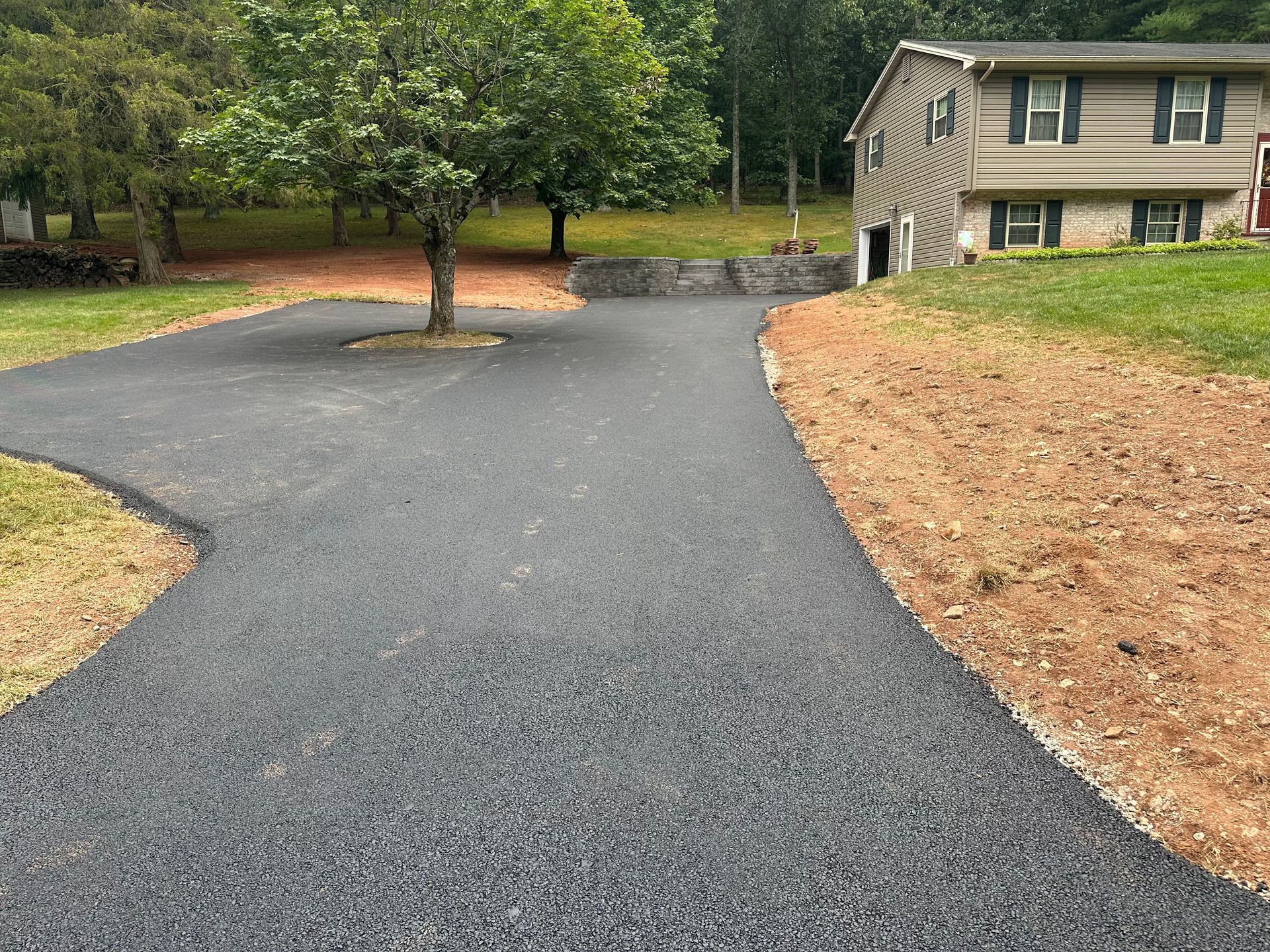 A brick building with a driveway in front of it.
