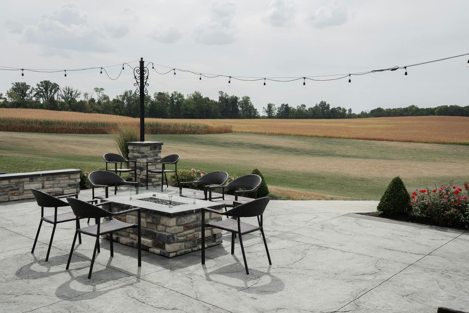 A bulldozer is working on a brick wall in a yard.