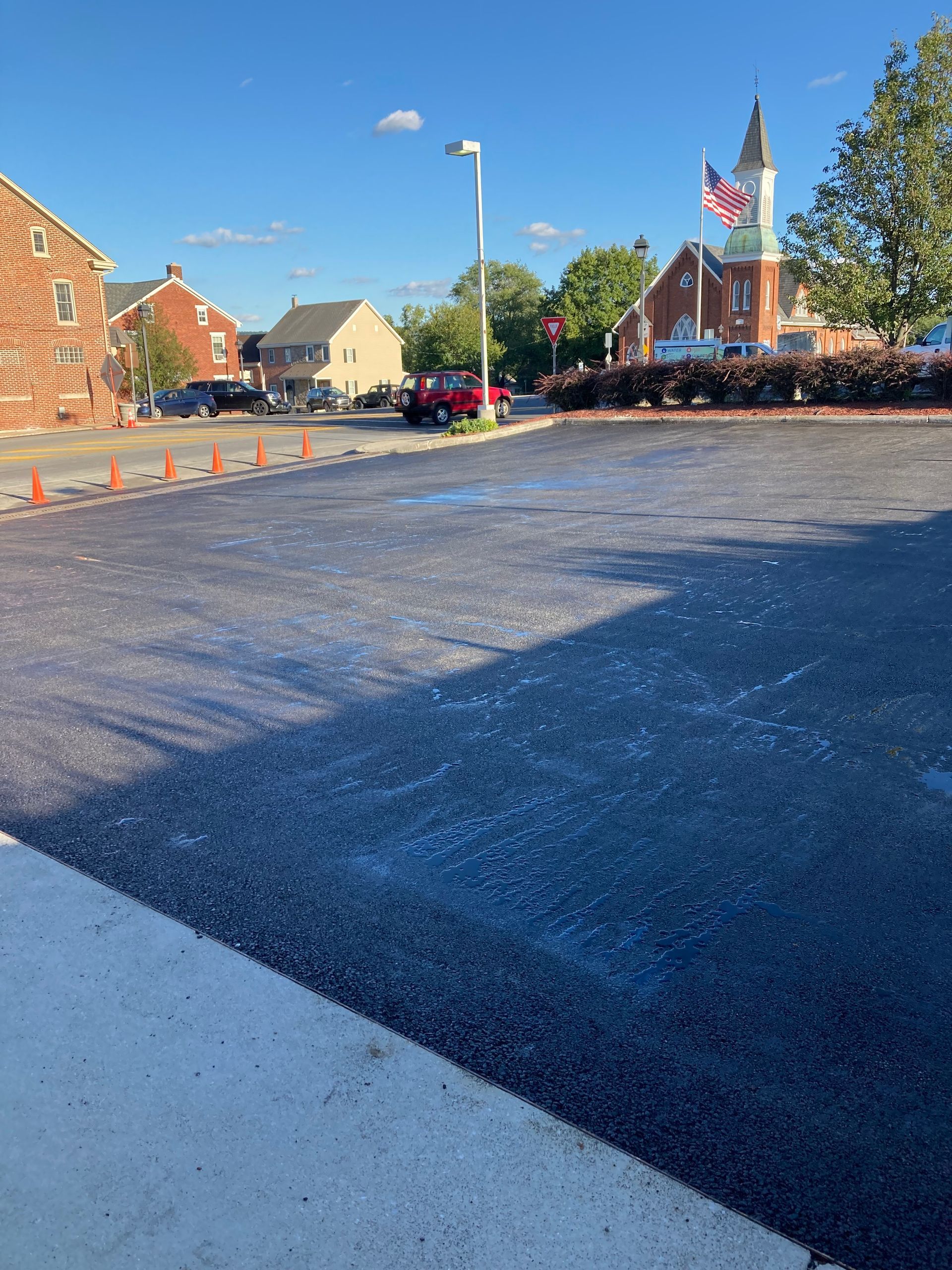 A parking lot with a brick building in the background
