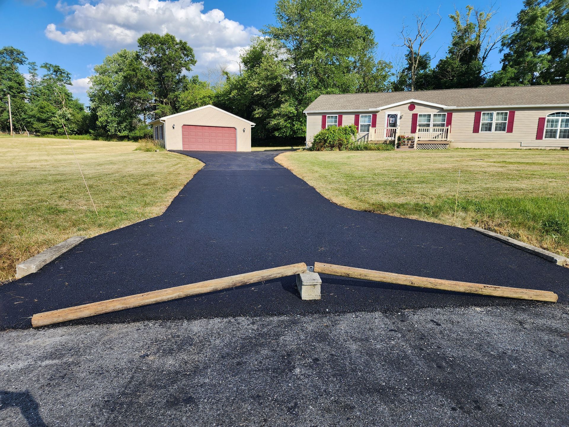 A house with a driveway leading to it and a garage.