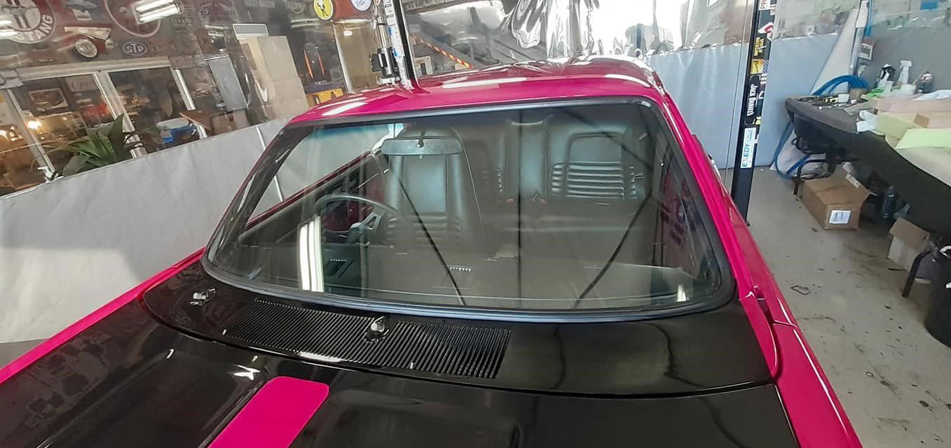 A Pink and Black Car is Parked in a Garage — FNQ Windscreens in Bungalow, QLD