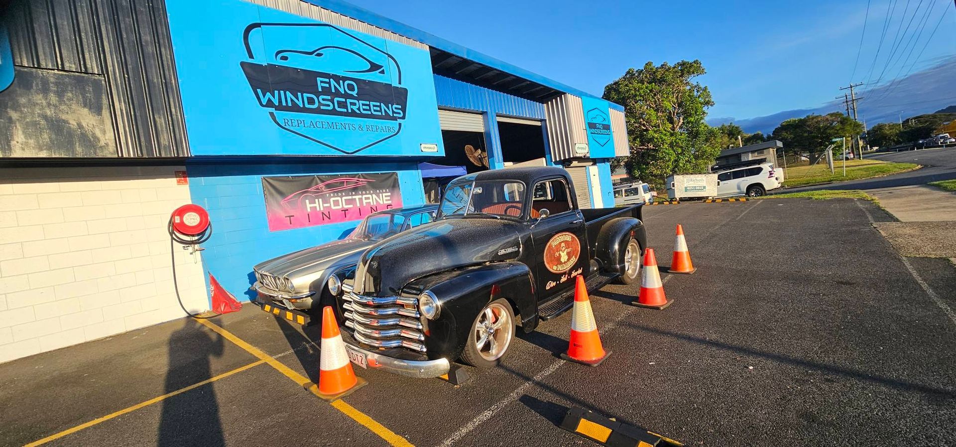 A Close up Of a Car Windshield Being Replaced in A Garage — FNQ Windscreens in Bungalow, QLD