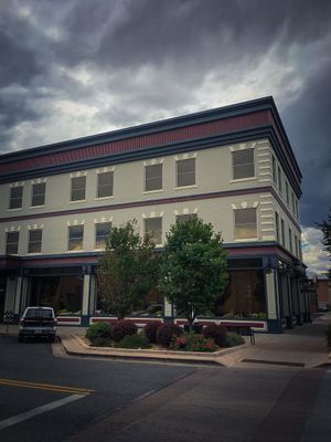 A large building with a car parked in front of it