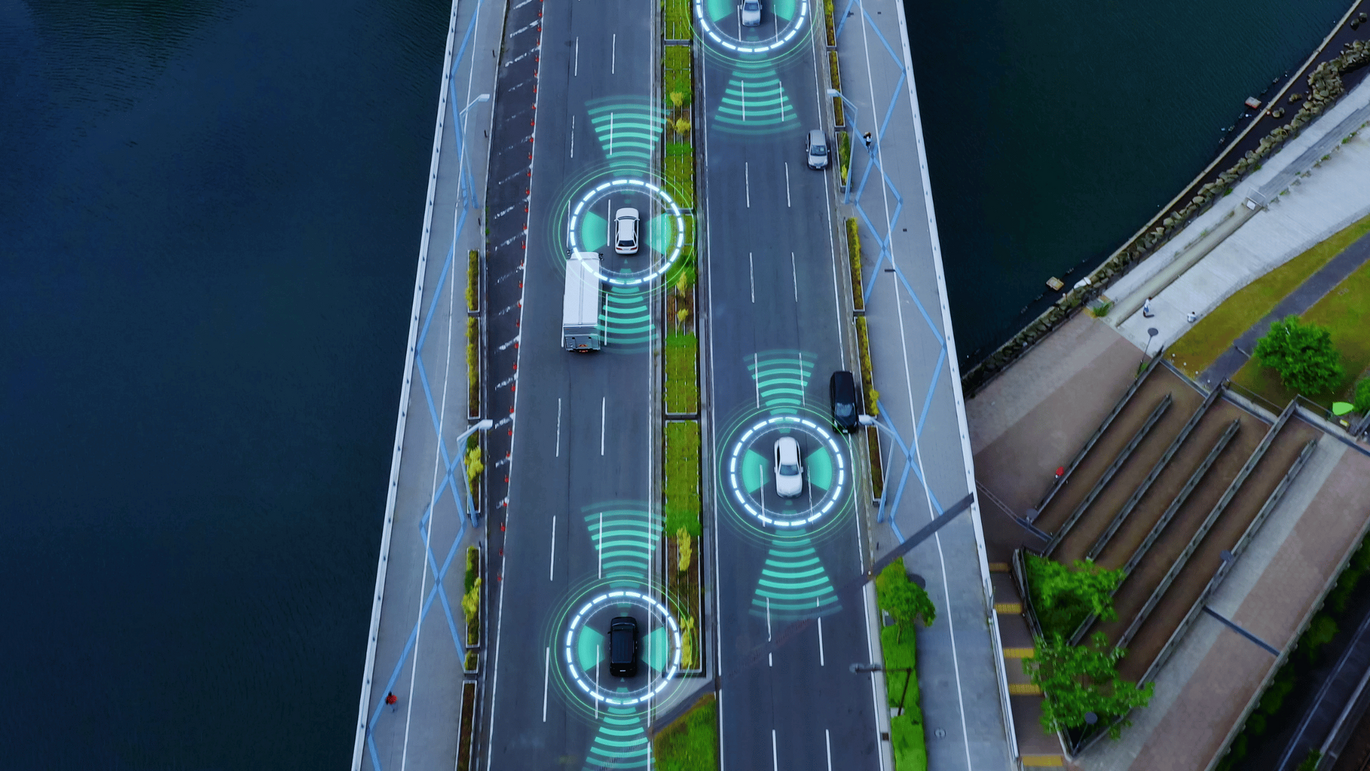 An aerial view of a bridge with cars driving on it.