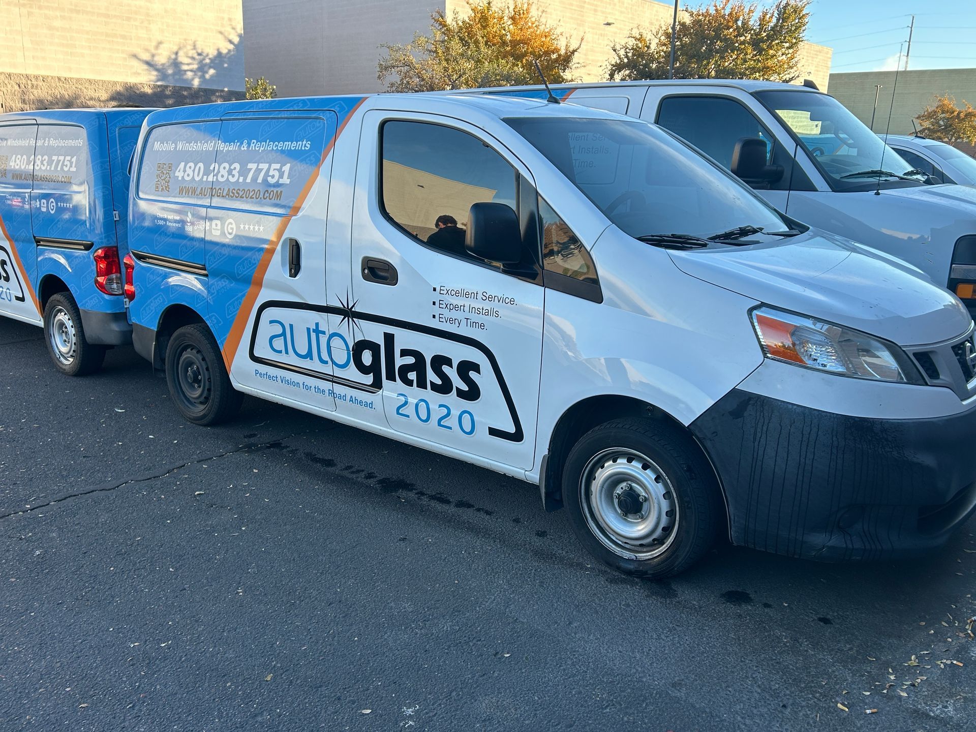 A row of Auto Glass 2020 vans are in Chandler AZ, getting ready to do mobile windshield replacements.