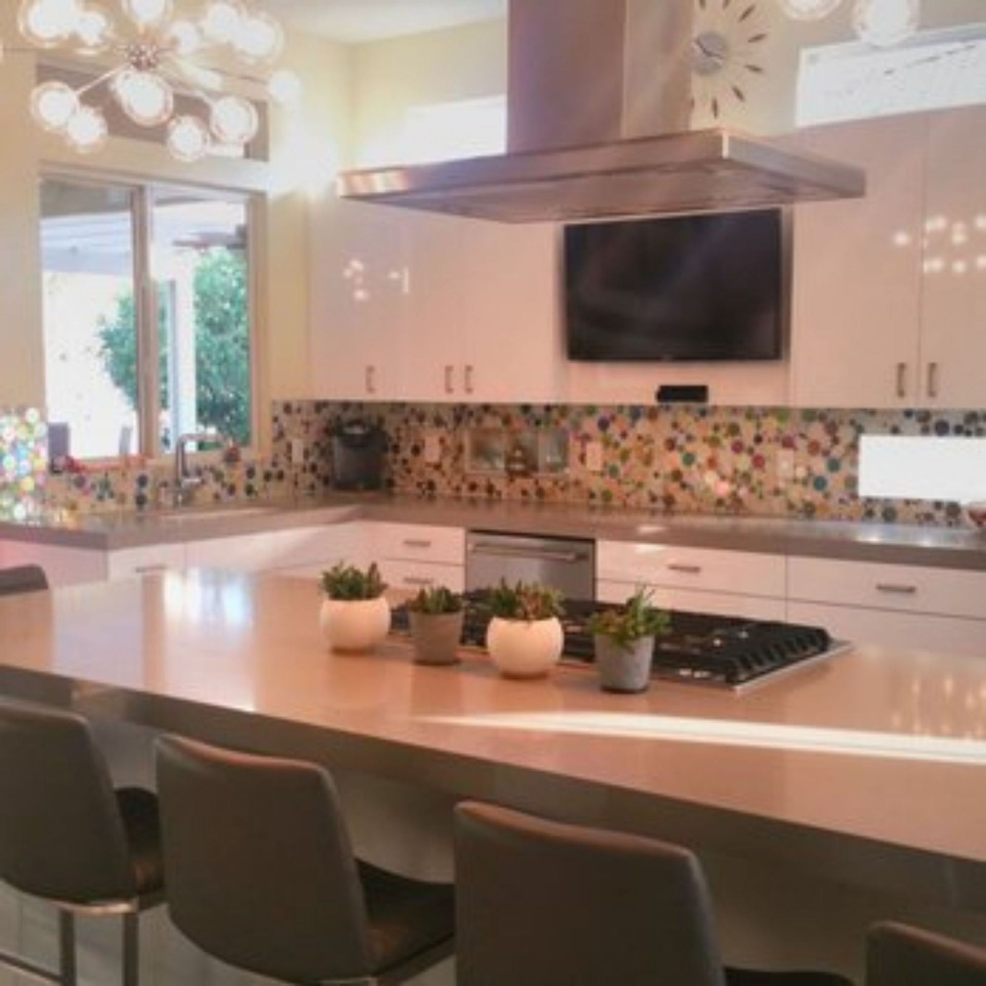 The right color - Modern kitchen with white cabinets, large island, and multi-colored backsplash.