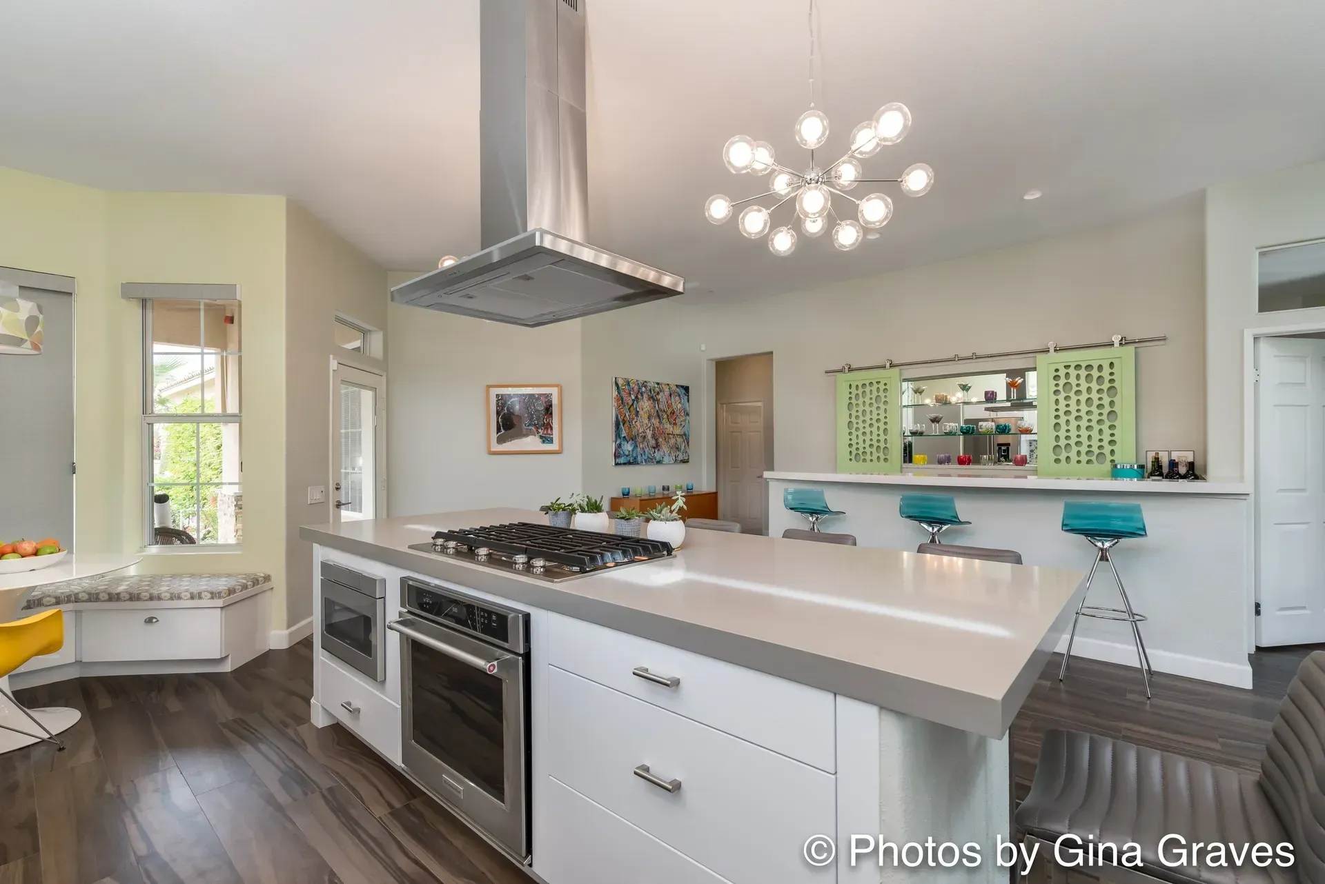 The right color - Modern kitchen with white island, stainless steel appliances, and turquoise bar stools.