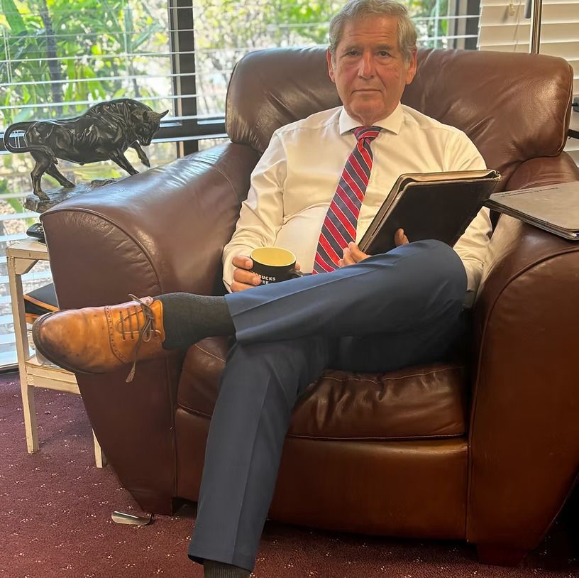 Ed Castagna in a suit and tie is smiling for the camera