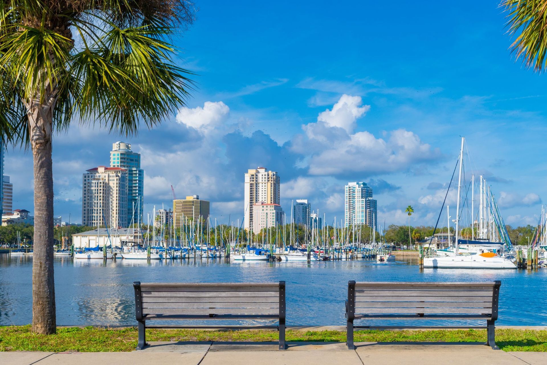 A man in a suit and tie is smiling for the camera
