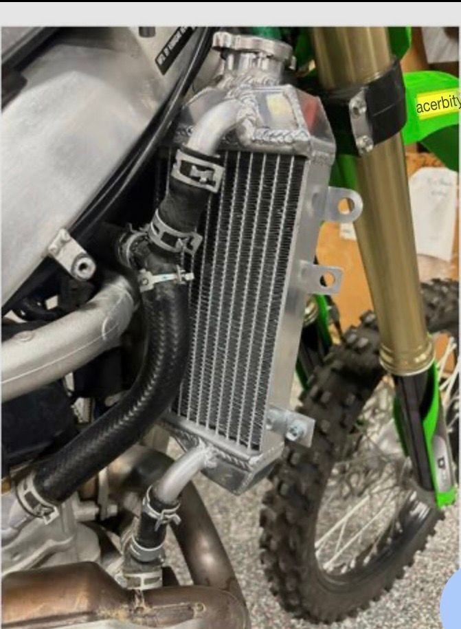 Red motorcycle speeding on a highway with a rider in full gear; sunset in the background.