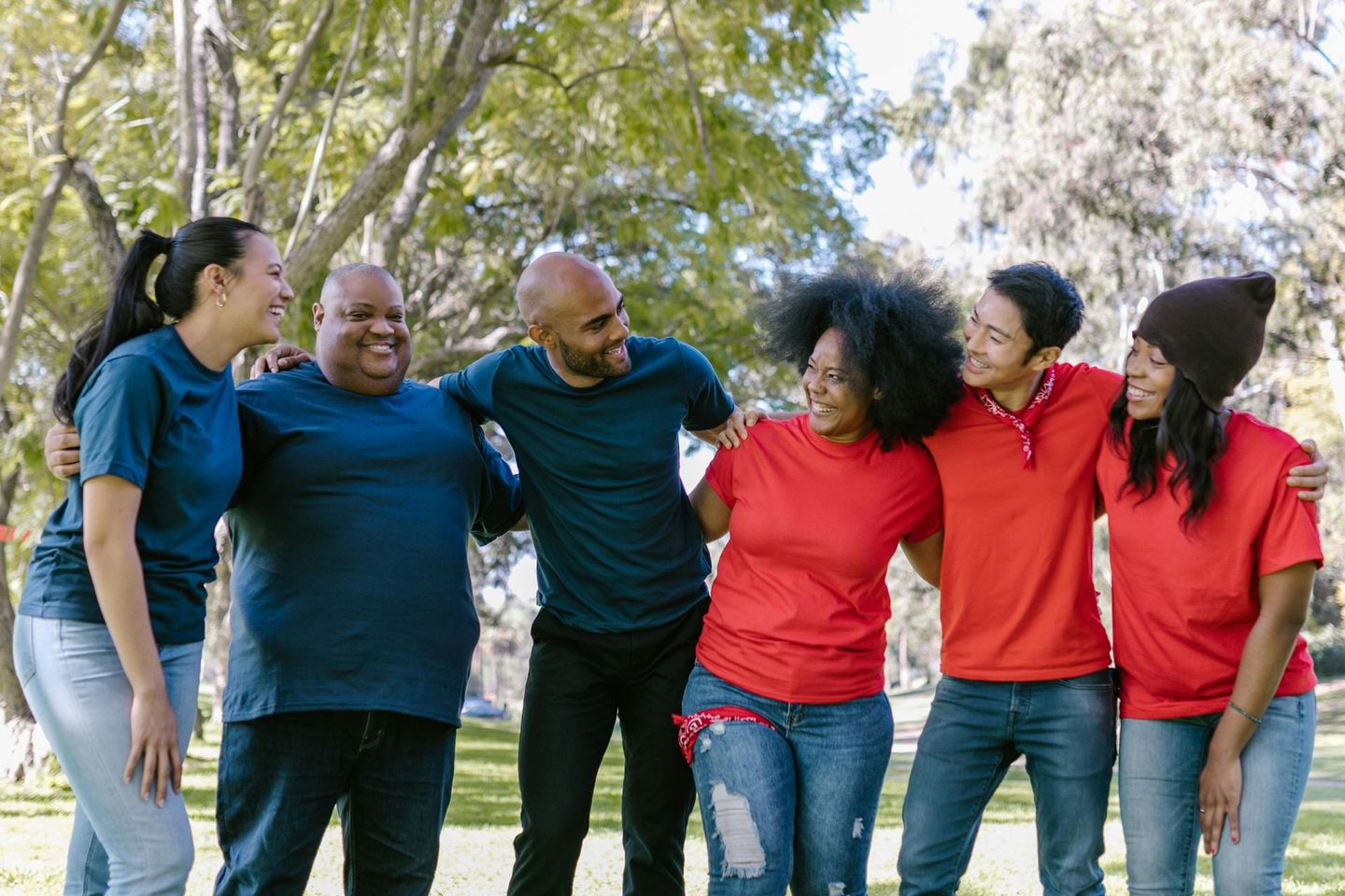 A group of people are standing next to each other in a park.