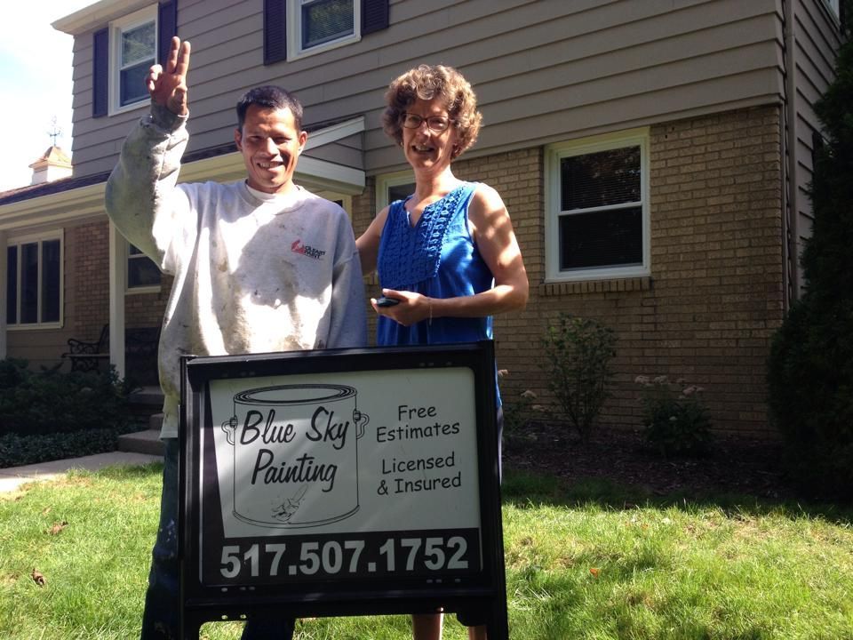 Man and woman stand in front of a house with a 