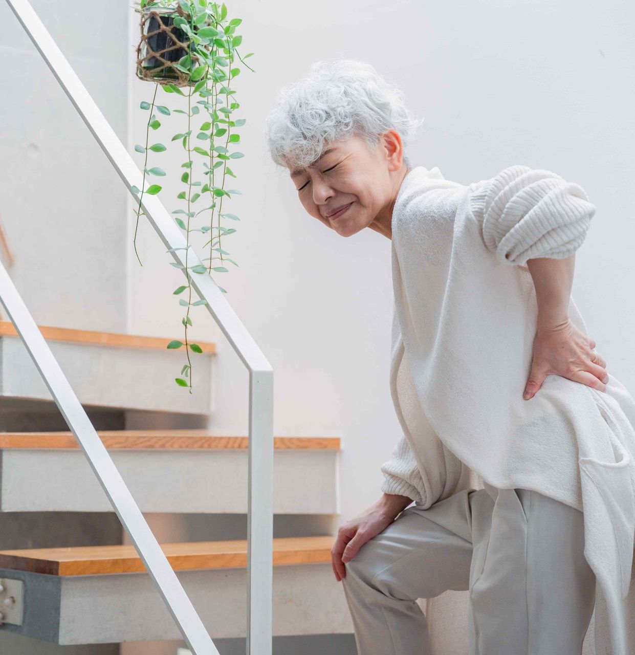 Before picture is an elderly woman in pain while climbing stairs.