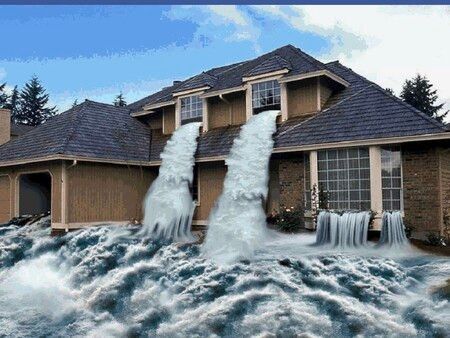 a house is flooded with water coming out of the roof .